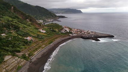Obraz premium Vista aérea: costa rocosa, vegetación exuberante.