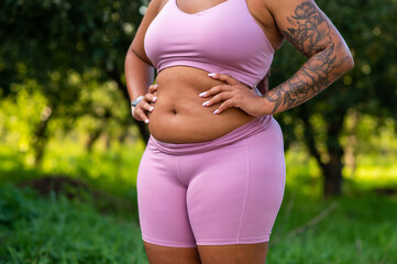 Closeup of stomach and chest of body positive woman in outfit