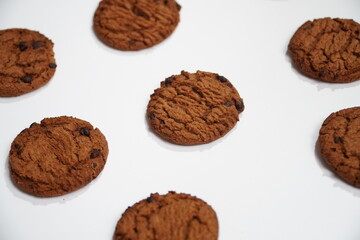tasty crunchy cookies with chocolate chips isolated on white background, top view