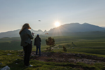 Sunset drone flying in Durmitor with paraglider in the distance