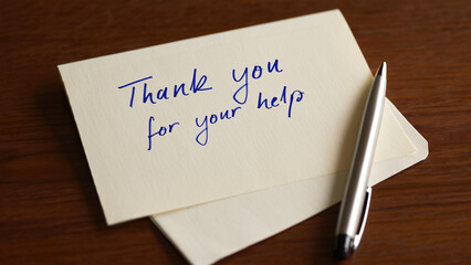 Hand writing thank you note on white card