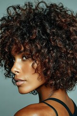 Striking Close-Up Portrait of a Beautiful Woman with Defined Auburn Curls and Radiant Skin, Captured with Intense Gaze and Natural Light