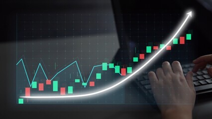 A close-up view of hands typing on a laptop with an overlay of a financial chart, demonstrating...