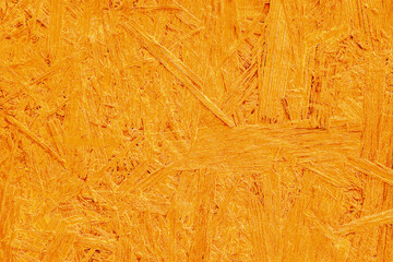Orange fiberboard background wood processing waste texture pressed wood bright