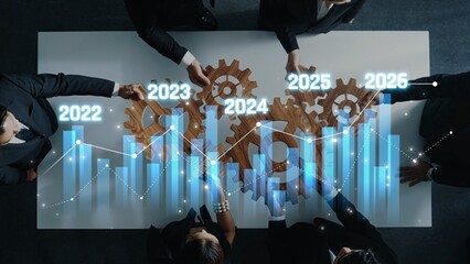 Business professionals engage in strategic planning, analyzing growth trends through charts and...