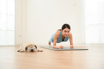 Woman Practices Yoga Indoors in a Serene Space With a Dog Resting Nearby