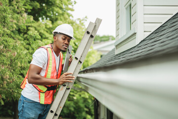 black man with hard hat to house inspector roof house