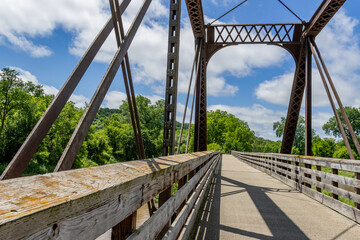 Historic Iron Truss Bridge Over River on Sunny Day