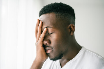 black man confident and casual at home. Portrait or headshot of a young men look sad