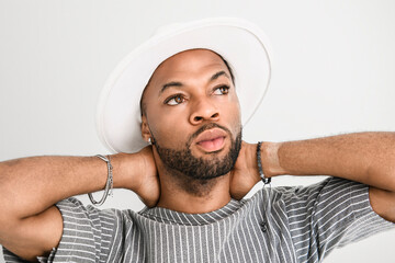 Portrait of black fashion American wearing great looking clothes with white hat