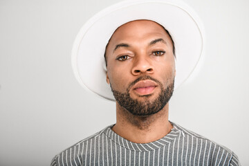 Portrait of black fashion American wearing great looking clothes with white hat