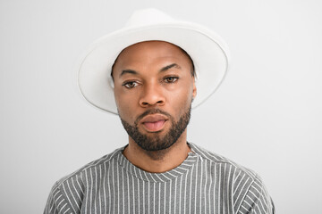Portrait of black fashion American wearing great looking clothes with white hat