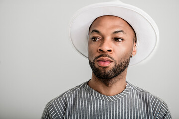 Portrait of black fashion American wearing great looking clothes with white hat