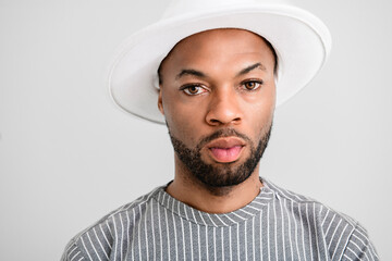 Portrait of black fashion American wearing great looking clothes with white hat