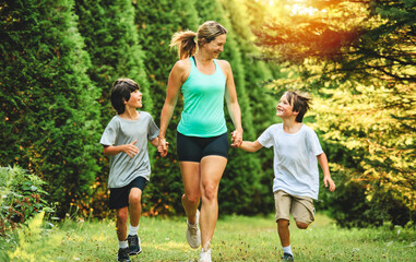 mother and son running outside in forest