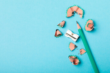 Pencil sharpener on bright colored background. Pencil and pencil shavings. Stationery. School supplies. School products. Flat lay. Place for text. copy space.