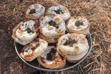 fresh Druze-style pita breads with labneh and zaatar on a tray