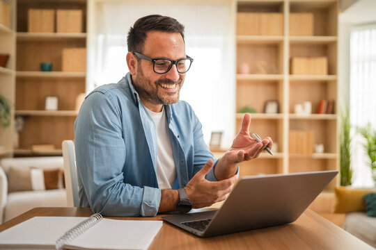 Happy entrepreneur making a video call from home office