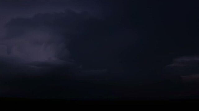 Dramatic Night Storm Cloudscape - Dark, brooding storm clouds fill the frame, illuminated by flashes of lightning. The ominous atmosphere is enhanced by the deep, purplish hues of the night sky.