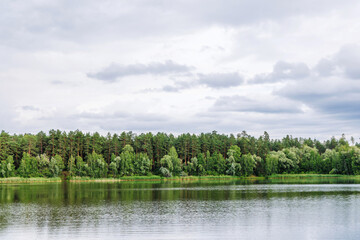 Scenic landscape with a calm lake surrounded by lush green forest