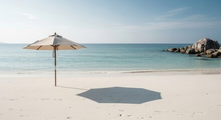 Serene Tropical Beach Umbrella Casting Shadow on White Sand