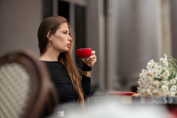 Woman Coffee Daisies: Lady with cup sits outside, enjoying morning coffee with flowers in daylight.