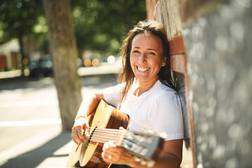 woman playing guitar at home living room © Louis-Paul Photo