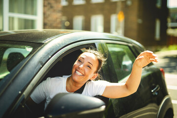 woman at car window drive a new car