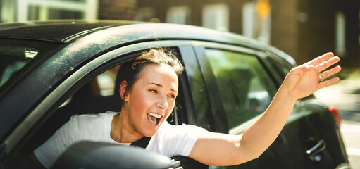 woman at car window drive a new car