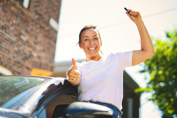woman at car window drive a new car