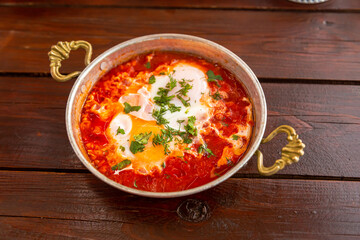 shakshuka with garlic and herbs in a small frying pan
