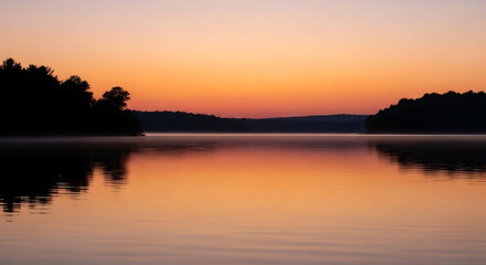 Calm lake reflecting the warm colors of the sunset with trees silhouetted against the sky line ai generated