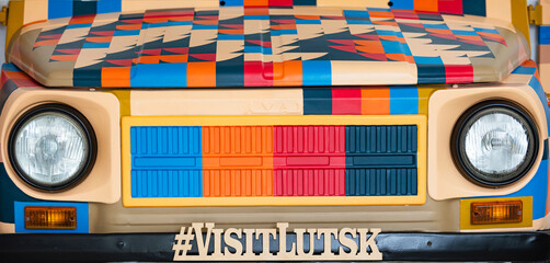 Colorful car with a VISITLUTSK hashtag