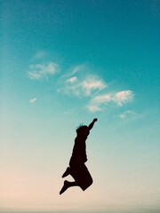 Fototapeta premium a small child jumping at dusk