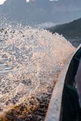 Close up of water splashing from the side of a boat in Canaima National Park
