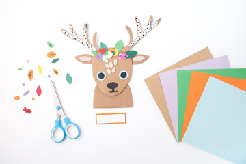 Creative diy cardboard reindeer with decorated antlers flat lay craft materials scissors glue...