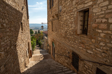 Naklejka premium Beautiful Tuscan historical street and place in the city of Assisi, Tuscany, Italy, Europe. Medieval atmosphere
