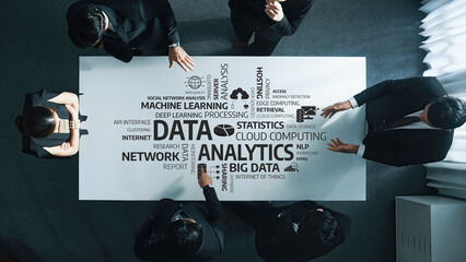 A diverse team collaborates around a modern office table, engaging in a discussion on data analytics, big data, and machine learning, showcasing innovation and teamwork. Amity