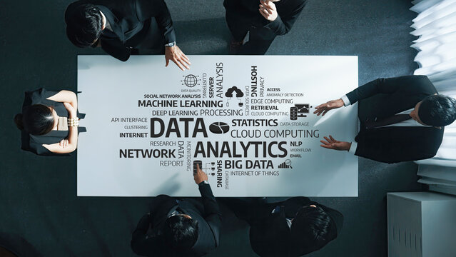 A diverse team collaborates around a modern office table, engaging in a discussion on data analytics, big data, and machine learning, showcasing innovation and teamwork. Amity