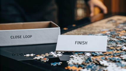 Finished Puzzle Piece on Table with Box and Close Loop Label