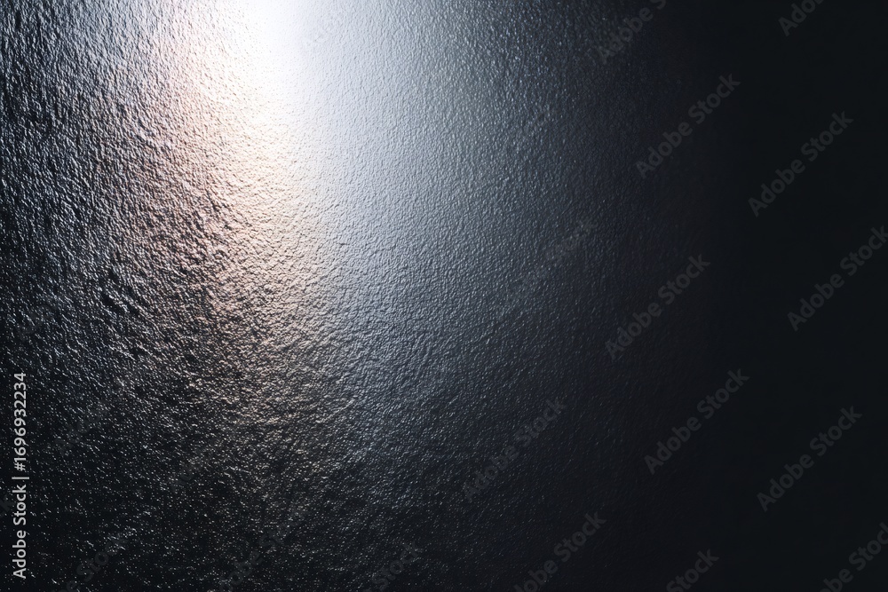 Poster metallic surface with irregular texture reflecting light and creating a gradient from bright to dark