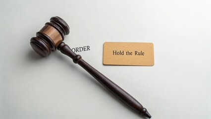 Wooden Gavel on Table with Hold the Rule Phrase and Order Text