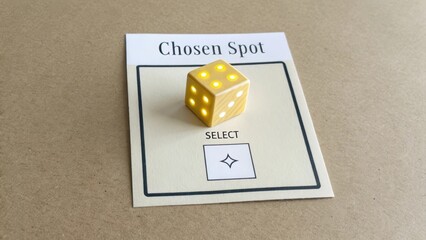 Yellow Dice on Cardboard Background with Chosen Spot Label