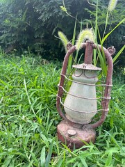 Old vintage lantern on green grass outdoors