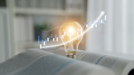 A lightbulb radiates energy above an open book, symbolizing knowledge and creativity, while a...
