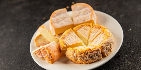 Cheese plate camembert, brie, munster french cheese tasty snack fresh delicious gourmet food background on the table rustic food top view copy space