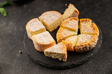 Cheese plate camembert, brie, munster french cheese tasty snack fresh delicious gourmet food background on the table rustic food top view copy space