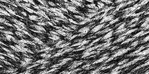 Close-up macro of a black and white fur textile, revealing its rough texture and natural hair pattern