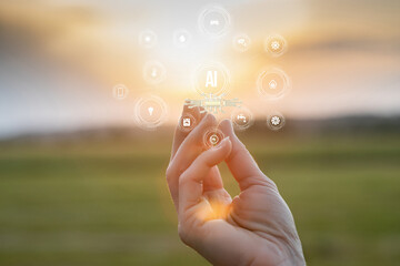 Holding technology in nature under the golden sunset glow.