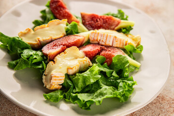 Salad figs, soft cheese, green leaf lettuce tasty snack fresh delicious gourmet food background on the table rustic food top view copy space keto and paleo diet vegetarian food